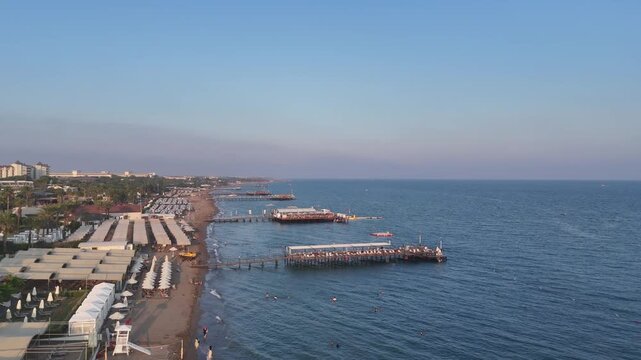 Aerial view  of majestic Belek Beachfront Paradise. Sandy beaches  of Mediterranean Sea. Belek Holiday Complex with five star hotels and resorts by sunset