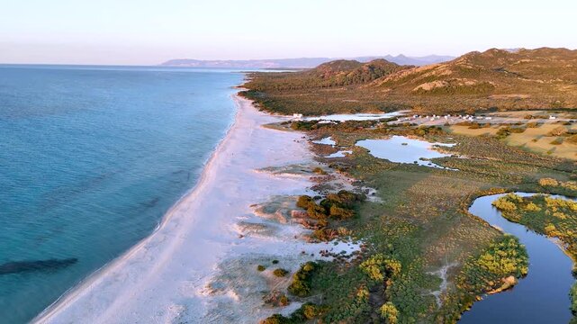 Aerial Sunrise Over Berchida Beach and Coastal Lagoons in Sardinia
