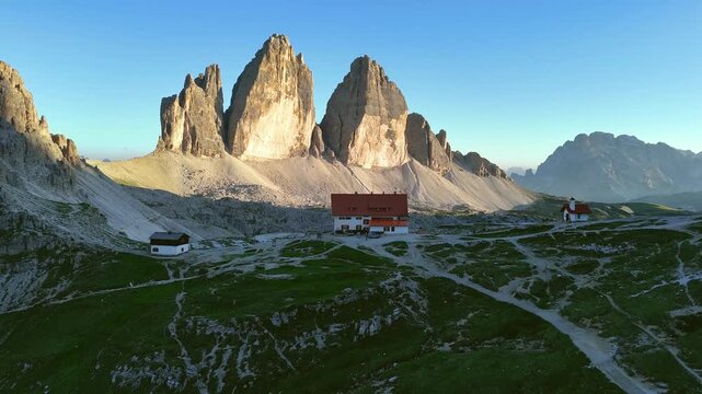 Forward Drone Flight Toward Tre Cime Peaks at Sunrise
