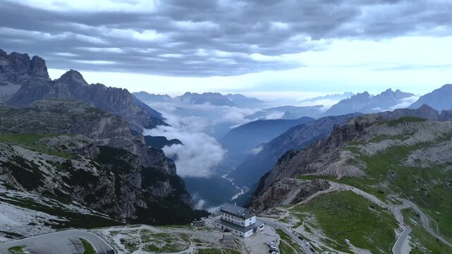 Forward Drone Flight Toward Auronzo Refuge in Foggy Dolomites
