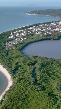 Florian&oacute;polis, Daniela Beach. Aerial View of Tropical Coastline. Establishing Shot. Santa Catarina, Brazil. Vertical video