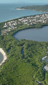 Florian&oacute;polis, Daniela Beach. Aerial View of Tropical Coastline. Establishing Shot. Santa Catarina, Brazil. Vertical video