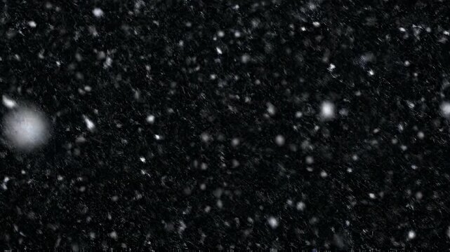 Gentle snowfall in a dark winter night with copy space for holiday greetings and winter themes