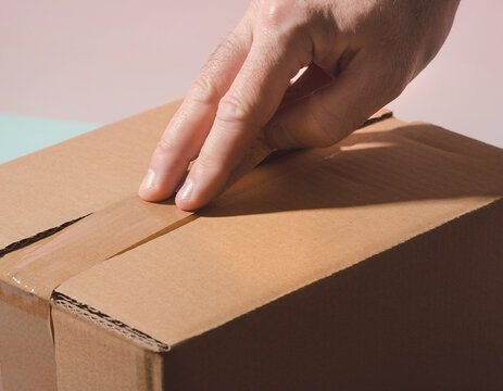 Kraft cardboard shipping box mockup with hand sealing flap