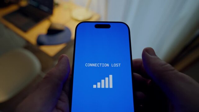 Close up on hands holding phone as message appear warning of loss of connection. Person with smartphone alert popping on mobile showing connection or signal icon error. Hacker or spy trying to connect