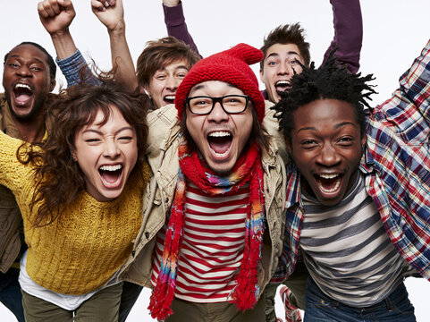 Excited Diverse Young Friends Celebrating and Cheering Together