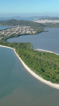 Florian&oacute;polis, Daniela Beach. Aerial View of Tropical Coastline. Establishing Shot. Santa Catarina, Brazil. Vertical video