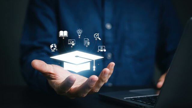 Person holding a virtual graduation cap with educational symbols above a laptop, representing online learning and digital education
