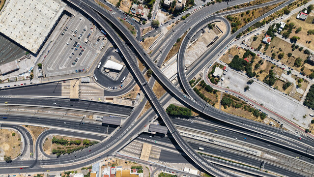 Aerial drone photo of urban multilevel highway junction road using multiple bridges forming a spaggheti road with light traffic