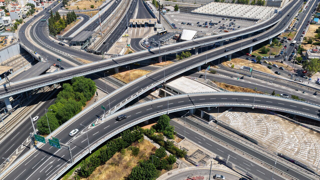Aerial drone photo of urban multilevel highway junction road using multiple bridges forming a spaggheti road with light traffic