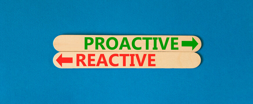 Proactive and reactive symbol. Concept word Proactive Reactive on beautiful wooden sticks. Beautiful blue background. Business proactive and reactive concept. Copy space.