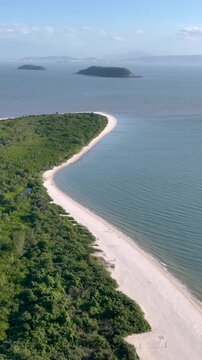 Florian&oacute;polis, Daniela Beach. Aerial View of Tropical Coastline. Establishing Shot. Santa Catarina, Brazil. Vertical video