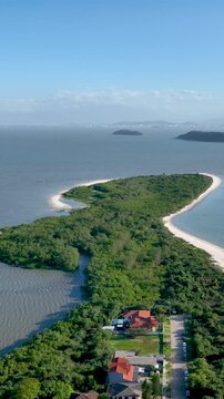 Florian&oacute;polis, Daniela Beach. Aerial View of Tropical Coastline. Establishing Shot. Santa Catarina, Brazil. Vertical video