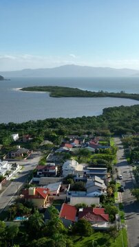 Florian&oacute;polis, Daniela Beach. Aerial View of Tropical Coastline. Establishing Shot. Santa Catarina, Brazil. Vertical video