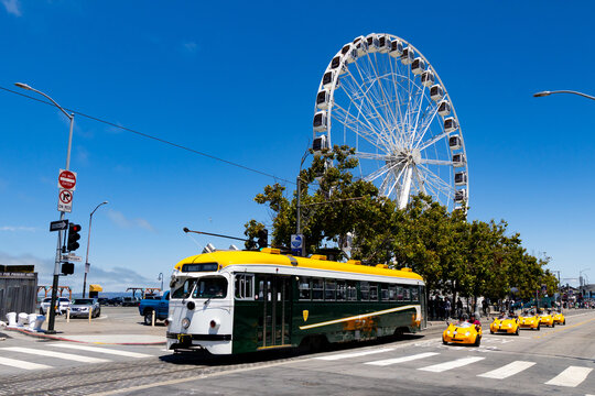 Vintage San Francisco streetcar near Fishermans Wharf with SkyStar Ferris wheel