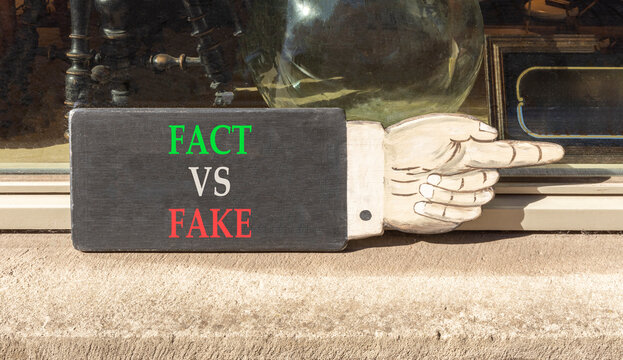 Fact vs versus fake words symbol. Concept words Fact vs Fake on beautiful black information sign. Beautiful shopfront background. Business and fact vs versus fake concept. Copy space.