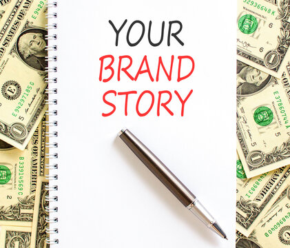Branding and your brand story symbol. Concept words Your brand story on beautiful white note. Beautiful dollar bills background. Business branding your brand story concept. Copy space.