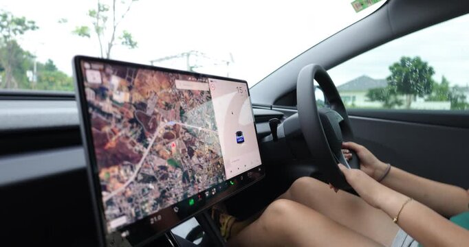Casual woman drive ev car navigator on screen transport technology