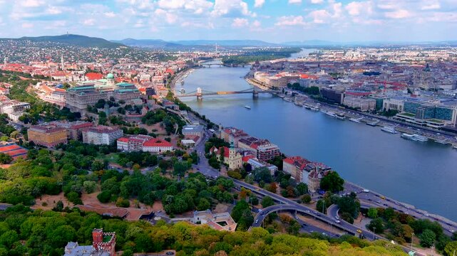 Aerial crane shot of the Buda Castle district with the Royal Palace, Matthias Church, Chain Bridge, Hungarian Parliament and Danube River, Budapest, Hungary, in summer.