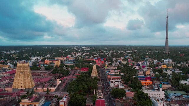 Aerial video of iconic Ramanathaswamy Temple, a magnificent Hindu pilgrimage site, with its towering gopurams and serene atmosphere.network of island and causeways that make up the Pamban Island group