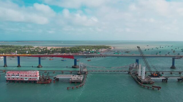 Aerial video of iconic Ramanathaswamy Temple, a magnificent Hindu pilgrimage site, with its towering gopurams and serene atmosphere.network of island and causeways that make up the Pamban Island group