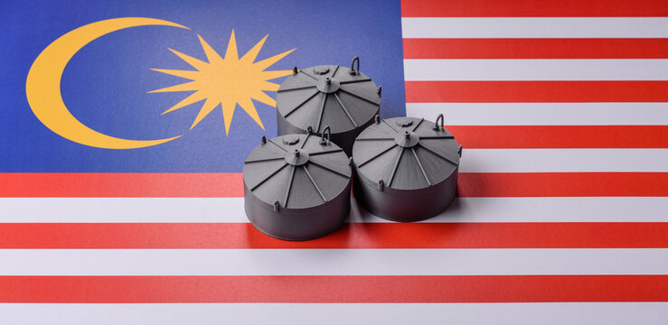 Liquefied gas storage tanks set against the Malaysian flag, concept of supply and distribution