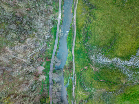 Stunning aerial flying drone landscape images of Thorpe Cloud in Peak Disdtrict during beautiful Autumn sunrise with amazing light