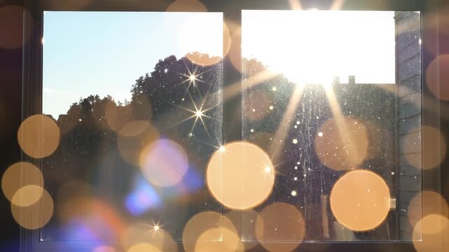 Golden sun flare through window with bokeh and lens effects during sunrise for nature backgrounds
