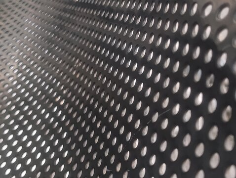 Stainless steel perforated metal sheet texture, industrial grid hole pattern background