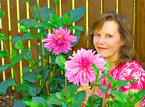 Portrait beside Lavender Perfection dahlias.