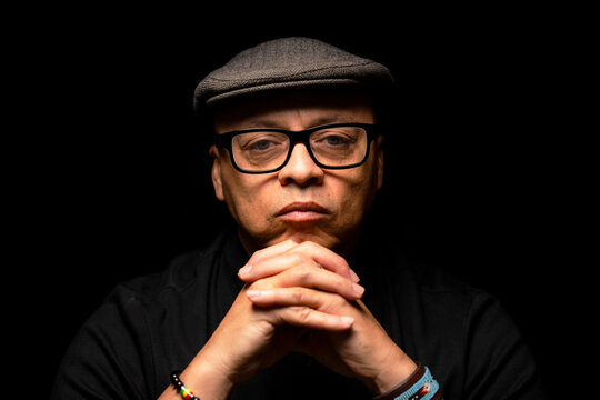 Handsome black man wearing glasses and a newsboy hat