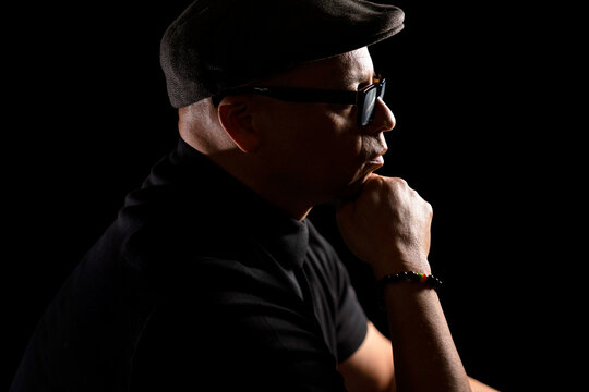 Handsome black man wearing glasses and a newsboy hat