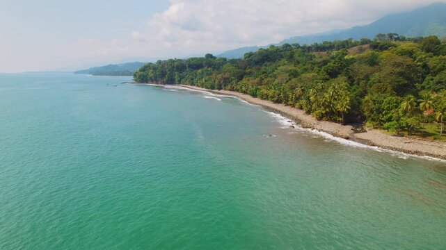 Beautiful aerial view of Pinuelas Beach with palm trees and sea in Costa Rica