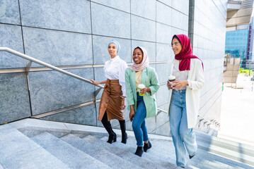 Obraz premium Beautiful muslim girl wearing hijab bonding outdoors