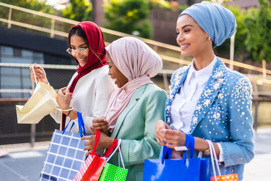 Beautiful muslim girl wearing hijab bonding outdoors