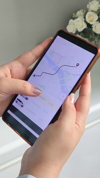 Woman ordering a taxi using a mobile phone, online taxi service, ride-hailing app, transportation and travel technology concept.