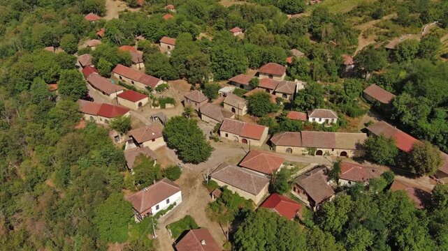 Aerial around view of old rustic vintage houses with wine cellars in Rogljevacke pivnice in Negotin region of Serbia, 4k
