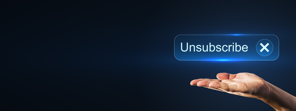 Hand presenting a glowing unsubscribe button on a dark digital background with generous copy space for email marketing, privacy, and notification concepts.