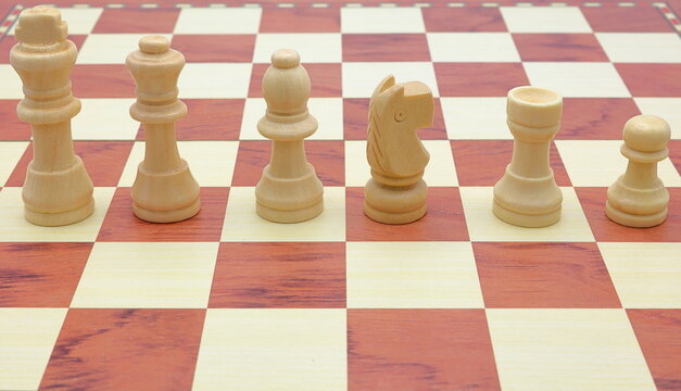 Wooden chess game. Concept pieces. Size order. King, queen, bishop, knight, rook and pawn.