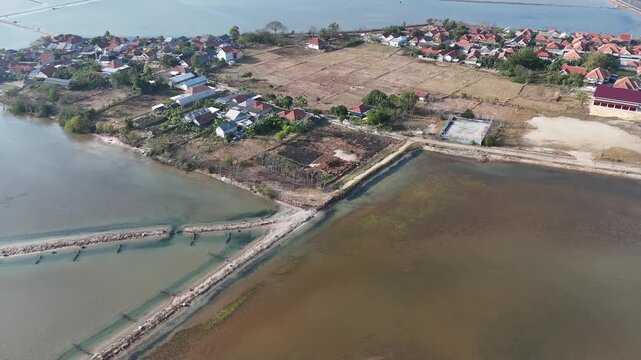 Aerial View of Coastal Village and Traditional Salt Ponds with Dirt Dikes