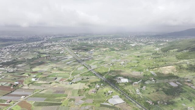 Aerial drone view of the Lien Khuong&ndash;Da Lat Expressway winding through the green mountain landscape around Nui Voi, Hiep Thanh Commune, Lam Dong Province, Vietnam.