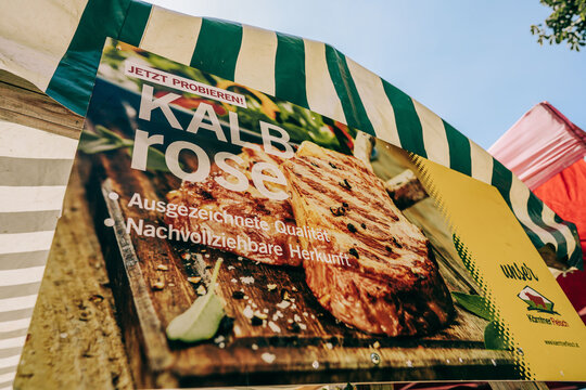 Ossiach, Austria - August 09, 2026: Promotional banner for Kalbrose featuring grilled meat on a wooden board at the Carinthian Rindfleischfest in Ossiacher Tauern