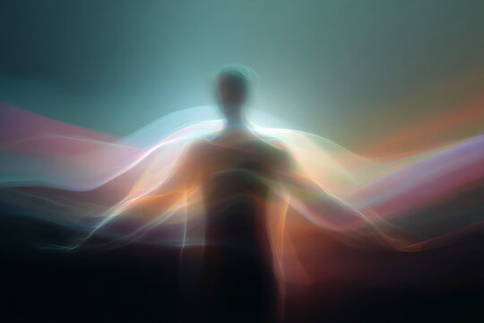 Human silhouette with multicolored aura waves and radiant light for spiritual meditation background and wellness poster design
