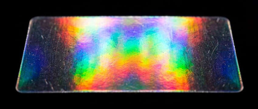 Prismatic holographic foil strip displays iridescent rainbow colors for advanced optical security protection on credit cards and IDs