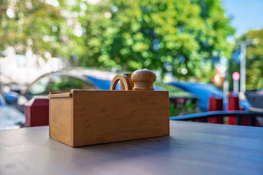 Wooden condiment holder on a cafe table outdoors