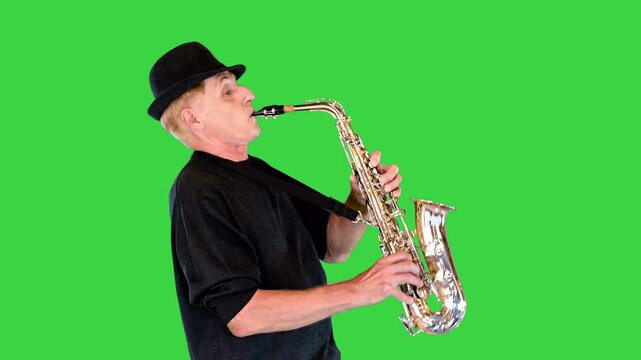 Professional jazz musician plays the saxophone masterfully on a Green Screen, Chroma Key.