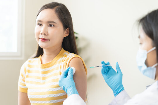 Health care, corona virus, hand of woman nurse, doctor giving syringe vaccine, injection dose on arm sick patient at clinic. Vaccination, immunization disease prevention against flu pandemic influenza