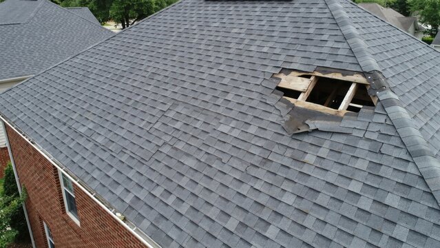 Aerial view of damaged residential roof shingles