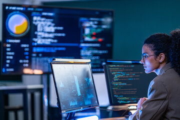 Brazilian IT security analyst reviewing malicious code patterns and firewall activity logs to...