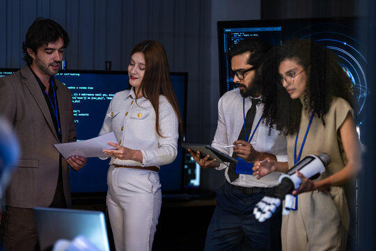Multi ethnic engineering team celebrating the successful deployment of a secure AI software project after resolving high priority security issues.